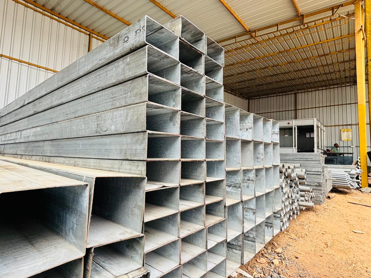 Wide view of the yard with stacked pipes and racks